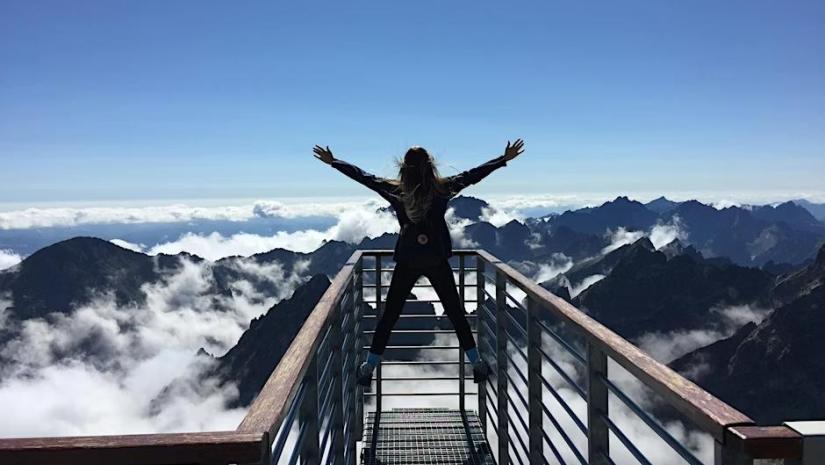 Person climbing a mountain top