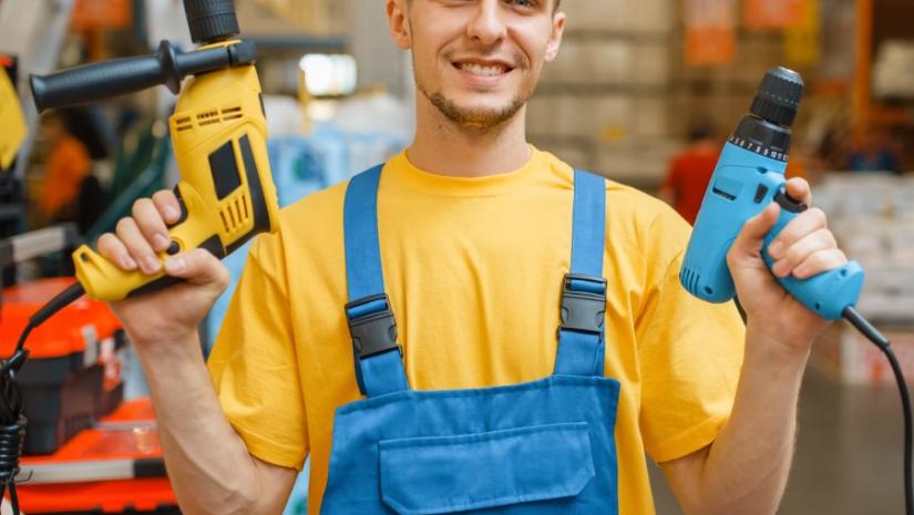 An image of a man holding tools