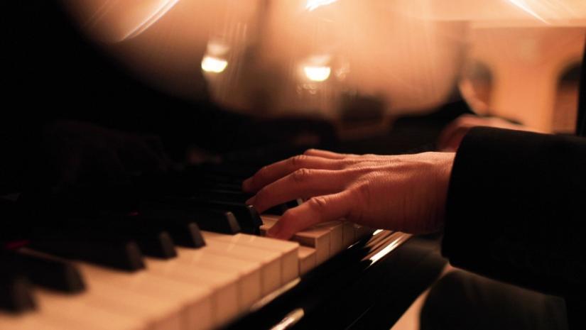 hands on piano keyboard