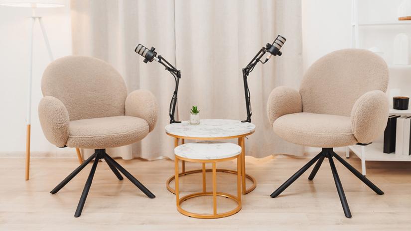 Two chairs with podcast microphones next to them.