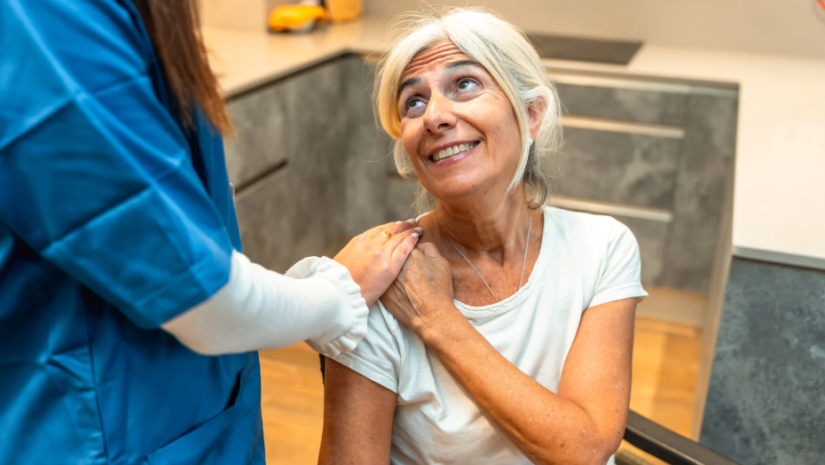 Older person and nurse talking