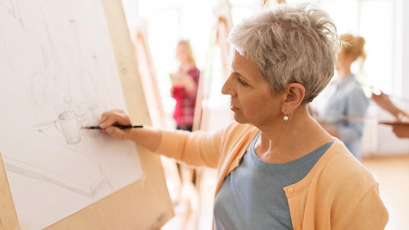 Image of a woman sketching a drawing