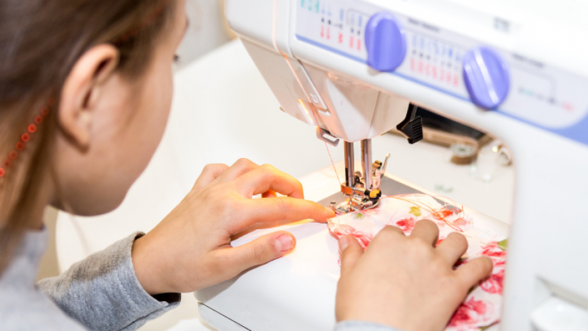 Young person sewing with machine