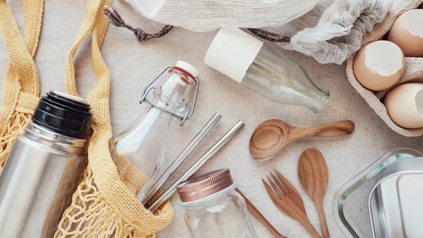 A collection of zero waste household items such as jars and spoons on a table.